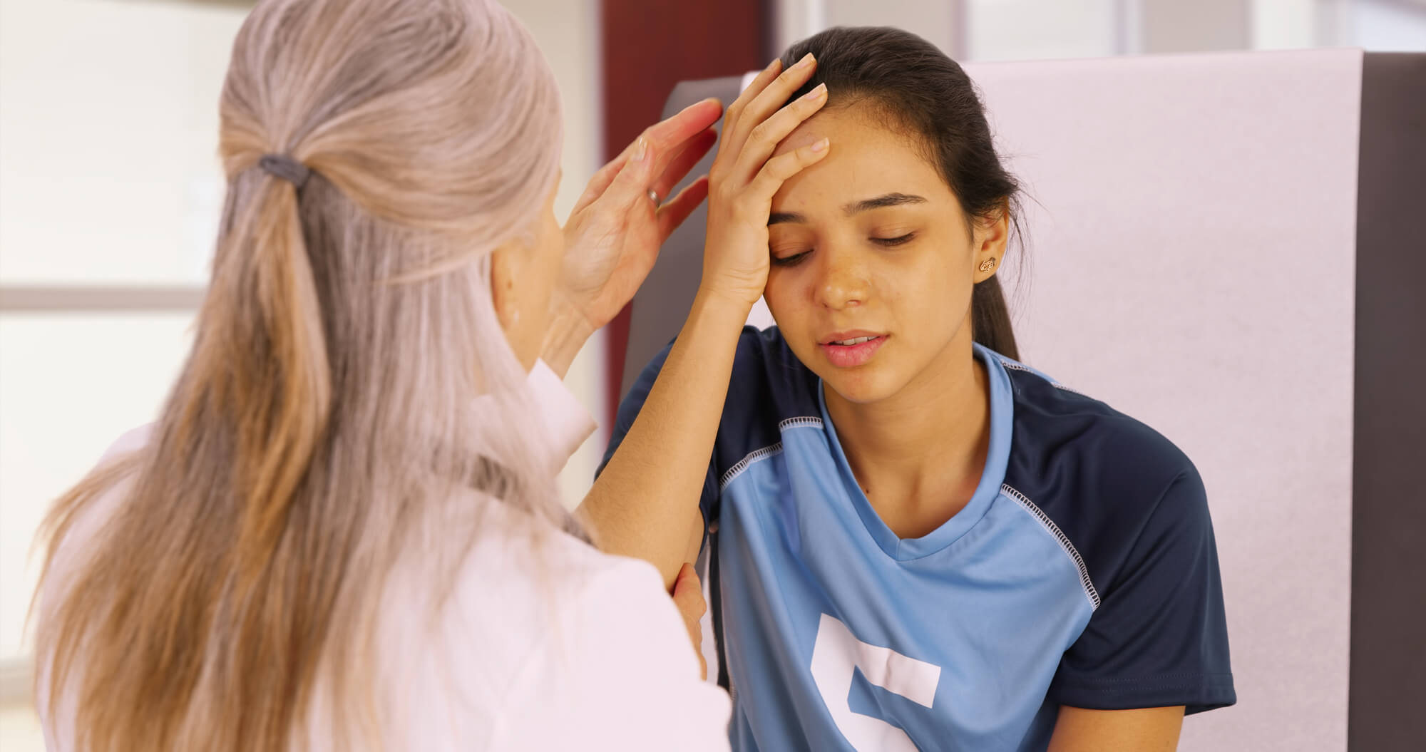 A woman having a concussion being treated by the nurse